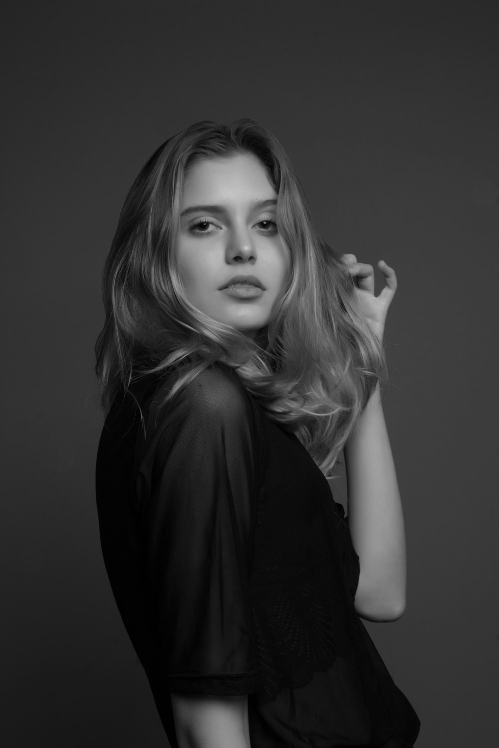 Model against textured wall shadow play